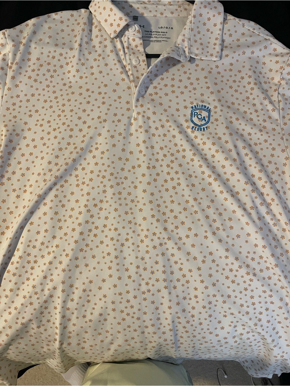 Under Armour White Polo with Tan Floral Print and Blue PGA Crest